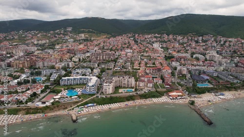 Aerial drone view of houses with red tiles and hotels, sea and beaches of Sveti Vlas in Bulgaria from above, top view from drone. Summer holiday in Europe. Black sea
