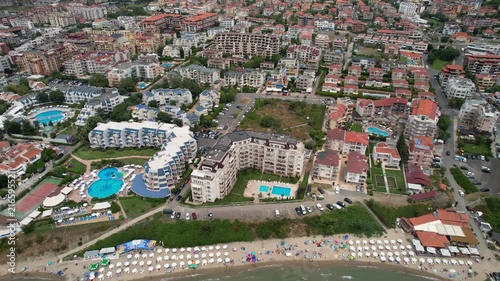 Aerial drone view of houses with red tiles and hotels, sea and beaches of Sveti Vlas in Bulgaria from above, top view from drone. Summer holiday in Europe. Black sea
