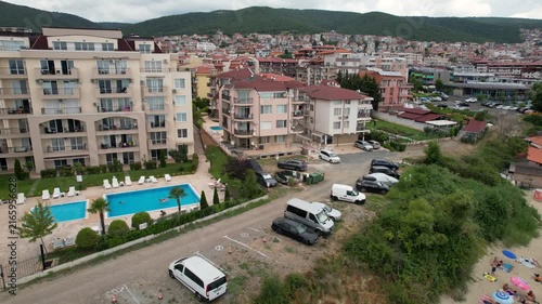 Panoramic aerial view of houses and hotels with pool, residential apartment, sea and beaches of Sveti Vlas in Bulgaria from above, top view from drone. Summer holiday in Europe. 
