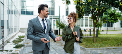 Business meeting takes place outside office building in city