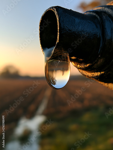 Water droplets clinging to the black pipe joint
