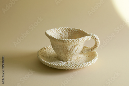 Teacup knitted from wool yarn surreal handmade craft concept