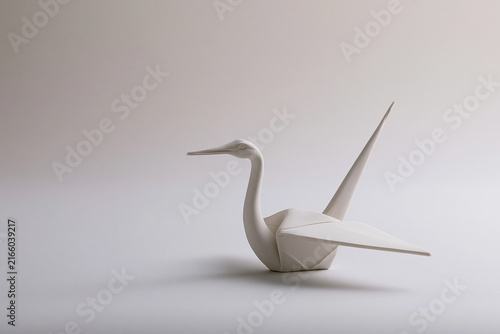 Origami crane sculpted from white ceramic surreal art concept