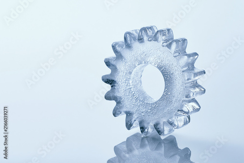 Gear cog carved from clear ice surreal frozen concept