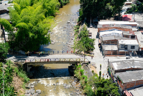 Aerial view of the Otún River and pedestrian bridge connecting Pereira with the San Judas neighborhood in Colombia