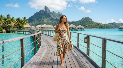 Woman walking on a wooden pier towards overwater bungalows in Bora Bora.
