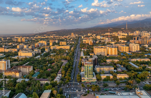 A picturesque drone view of the Kazakh city of Almaty at sunset on a summer evening.