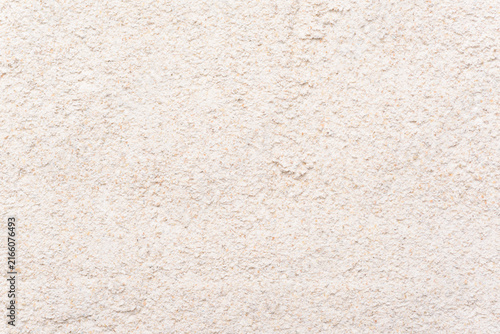 Close-up texture of organic rye flour, grey grain powder background, top view