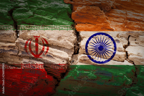 Iran and India Flags on Cracked Wood Texture