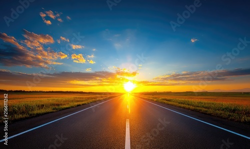 Sunset highway, golden light on empty road