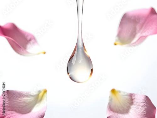 Petal Perfection: A single, perfect drop of clear liquid descends, surrounded by delicate, pink rose petals in a study of beauty and purity.