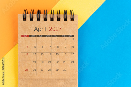 April 2027 brown color mini calendar on colorful background.