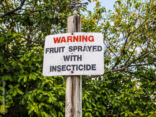 BRISBANE, AUSTRALIA - SEPTEMBER 27, 2012: Warning sign stating fruit sprayed with insecticide at Brisbane Botanic Gardens Mt Coot-tha