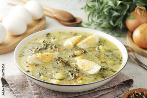 A bowl with traditional Polish sorrel soup Zupa Szczawiowa