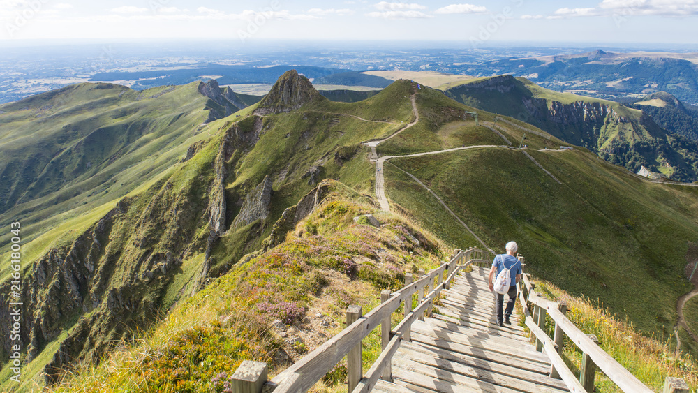 Fototapeta premium randonneur sur les escaliers du sommet du Puy de Sancy dans les Mont dore dans le Puy de Dôme en Auvergne, sommet volcanique de la Chaîne des Puys en France 