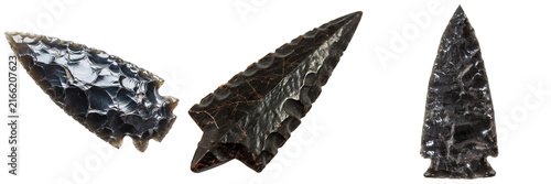 Photography Three obsidian arrowheads, ancient tools, isolated on white background