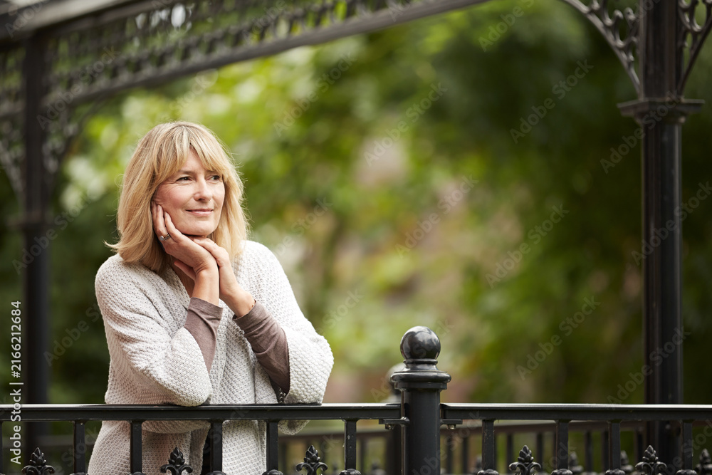Fototapeta premium Balcony, space and thinking with woman in garden of home for fresh air, reflection or vision. Contemplation, morning and quiet with mature person outdoor at apartment for memories, nostalgia or peace