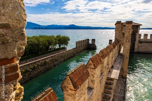 Canvastavla Port of Sirmione sheltered by the fortifications of the Rocca Scaligera on Lake