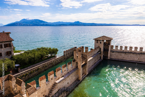 фотографія Port of Sirmione sheltered by the fortifications of the Rocca Scaligera on Lake