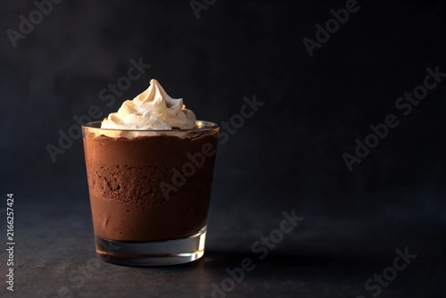 Chocolate mousse dessert in a glass with cream swirl