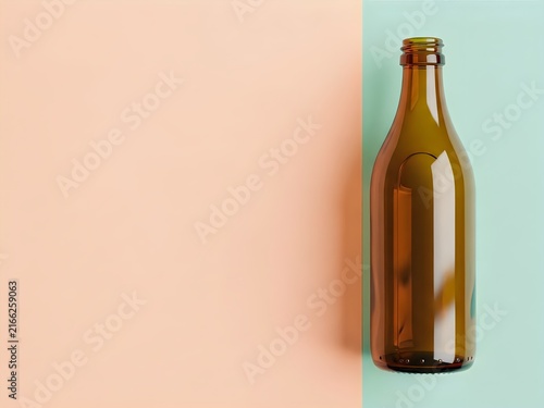 Amber glass bottle on split pastel pink and mint green background with copy space