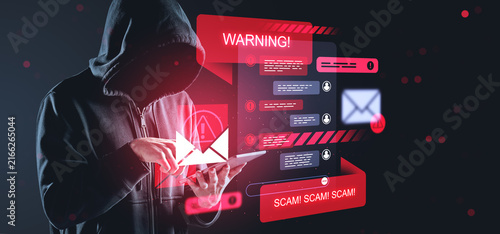 Konstfotografi Hooded cybercriminal using tablet with warning alerts, scam messages and phishing symbols in a dramatic creative cybersecurity background concept
