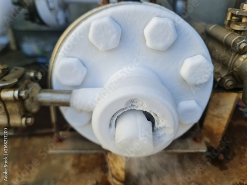 Konstfotografi Close-up of frozen pipe flange emitting cold steam and thick ice formation in cr