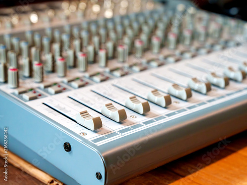 Obraz na płótnie Close-up of audio mixing console with faders and knobs