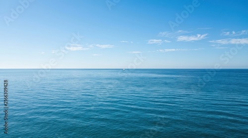 calm and vast open blue ocean seascape under clear sky