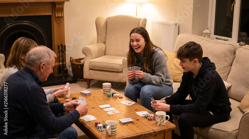 Family members play card games together in a cozy living room