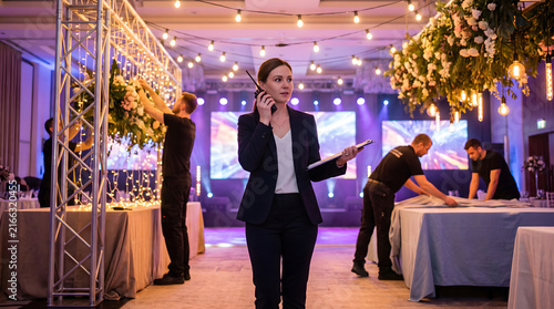 Event Coordinator Preparing Venue for Celebration with Staff