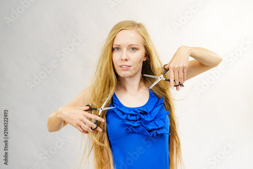 Girl with scissors for haircutting