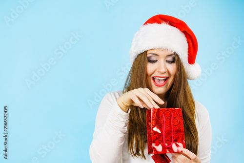 Christmas woman puts her hand into gift bag