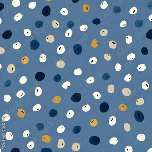 Seamless pattern of oval seed shapes on blue background with navy cream beige and gold spots, abstract modern textile style