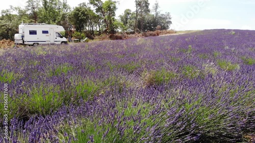 Caravan camping on nature at lavender field. Provence in France. Attraction trip for french vacation. Travel with mobile home. Drone shot
