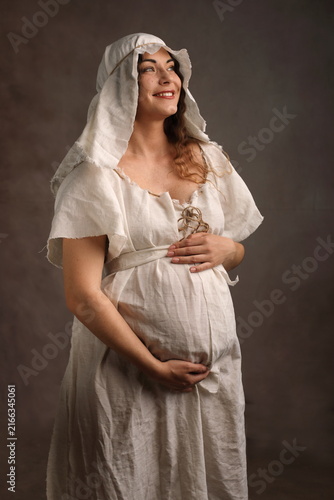 Happy Pregnant Woman in Medieval Dress with Authentic Natural Skin
