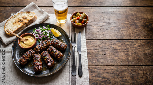 Romanian dish mici on a table seen from above with copy space, ad image traditional romanian food