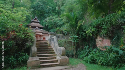 Temple staircase to peaceful shrine in tropical forest, Traditional Buddhist Wat Phra Lat sanctuary by lush jungle garden, Chiang Mai Thailand 4k