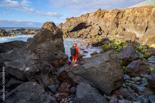 Photographer shooting a coastal cave