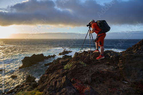 Photographer shooting the coastal sunset