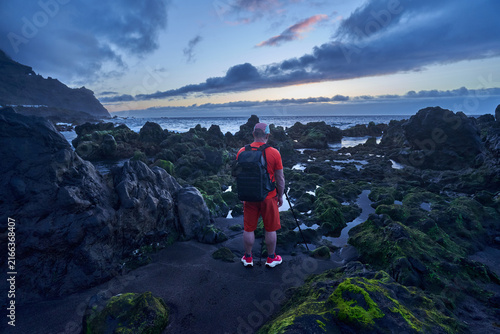 Photographer on the coast at twilight