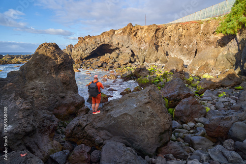 Photographer shooting a coastal cave