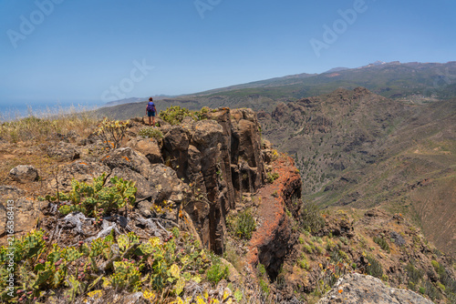 Woman hiking at the cliff edge