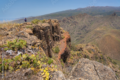 Woman hiking at the cliff edge