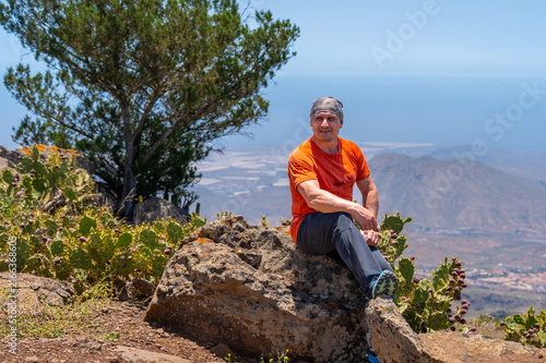 Hiker resting on a summit rock