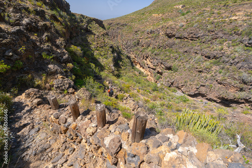 Hiker descending into a ravine