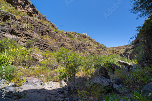 Hiker photographing a volcanic ravine