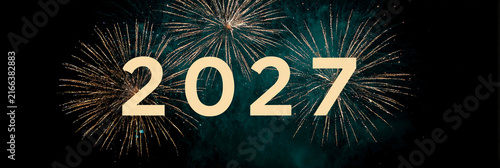 Golden '2027' number floats amid dazzling fireworks against dark sky. Perfect for new year, anniversary, or futuristic event designs. Celebratory and elegant visual with glowing sparkles