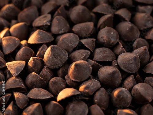 Pile of chocolate chips filling frame texture background cocoa sweet dessert confectionery brown