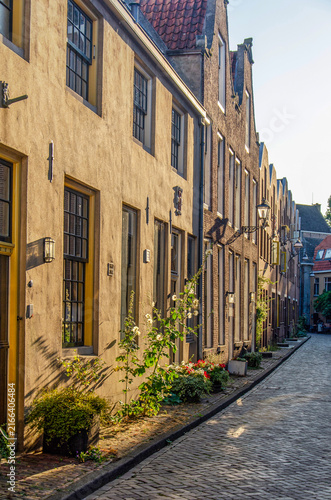 Zwolle, The Netherlands, July 27, 2026: evening sun illuminating brick and plaster facades in a street in the old town